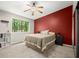 Neutral bedroom featuring a red accent wall, a ceiling fan, and lots of natural light at 301 Parkaire Xing, Marietta, GA 30068
