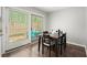 Bright dining area with a modern table and chairs, adjacent to a patio door for seamless indoor-outdoor living at 301 Parkaire Xing, Marietta, GA 30068