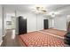 Spacious foyer featuring a large mirrored wall, patterned rug, and views of the living spaces and modern staircase at 301 Parkaire Xing, Marietta, GA 30068