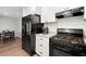 Well-lit kitchen features stainless steel appliances, granite countertops, and white cabinets at 301 Parkaire Xing, Marietta, GA 30068