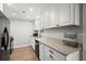 Modern kitchen featuring white cabinets, sleek black appliances, and granite countertops, perfect for culinary enthusiasts at 301 Parkaire Xing, Marietta, GA 30068