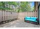 Private patio features a comfortable blue outdoor sofa perfect for relaxing and enjoying the outdoor space at 301 Parkaire Xing, Marietta, GA 30068