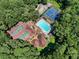 Aerial view showcasing the pool and tennis courts surrounded by lush greenery at 4875 Rivercliff Sw Trce, Lilburn, GA 30047