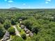 Scenic aerial view of a home nestled among lush trees with a glimpse of Stone Mountain at 4875 Rivercliff Sw Trce, Lilburn, GA 30047