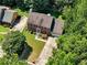 Aerial view shows a house with a well-manicured lawn, driveway, and lush landscaping at 4875 Rivercliff Sw Trce, Lilburn, GA 30047