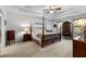 Serene bedroom featuring a four-poster bed, soft lighting, and ample space, providing a relaxing retreat at 4875 Rivercliff Sw Trce, Lilburn, GA 30047
