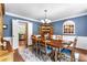 Formal dining room with stylish decor, wainscotting and ample space for entertaining guests at 4875 Rivercliff Sw Trce, Lilburn, GA 30047