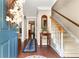 Inviting foyer with hardwood floors, staircase, and view into other living areas of the home at 4875 Rivercliff Sw Trce, Lilburn, GA 30047