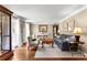Cozy living room featuring hardwood floors, neutral paint, natural light, and comfortable seating at 4875 Rivercliff Sw Trce, Lilburn, GA 30047