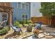 Charming backyard with a fire pit, cozy chairs, and lush landscaping, creating a relaxing outdoor retreat at 606 Lorimore Pass, Canton, GA 30115