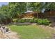 Picturesque backyard with mature trees, lush greenery, and a well-maintained lawn, offering a serene and private outdoor space at 606 Lorimore Pass, Canton, GA 30115