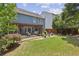 Expansive backyard featuring a patio, pergola, outdoor seating, and a well-maintained lawn, ideal for outdoor enjoyment at 606 Lorimore Pass, Canton, GA 30115