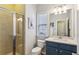 Stylish bathroom featuring a glass-enclosed shower, toilet, vanity with sink, and decorative accents, providing comfort at 606 Lorimore Pass, Canton, GA 30115