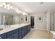 Lavish primary bathroom featuring double sinks, a large mirror, a separate shower, and neutral tones at 606 Lorimore Pass, Canton, GA 30115