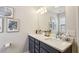 Modern bathroom with double sinks, a large mirror, and stylish fixtures, complemented by elegant decor and ample counter space at 606 Lorimore Pass, Canton, GA 30115