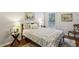 Cozy bedroom featuring a large bed with patterned bedding, a side table with a lamp, and natural light from the window at 606 Lorimore Pass, Canton, GA 30115