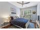 Light and airy bedroom featuring a ceiling fan, patterned rug, and nautical decor, creating a relaxing space at 606 Lorimore Pass, Canton, GA 30115