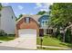 Charming two-story home featuring a brick facade, manicured lawn, and attached two car garage at 606 Lorimore Pass, Canton, GA 30115