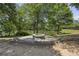 Community fire pit area with stone seating and wooded backdrop for cozy gatherings at 606 Lorimore Pass, Canton, GA 30115