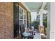 Inviting front porch with rocking chairs offers a relaxing outdoor space with brick accents at 606 Lorimore Pass, Canton, GA 30115