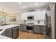 Bright kitchen with an island, stainless steel appliances, and updated fixtures at 606 Lorimore Pass, Canton, GA 30115