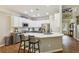 Modern kitchen with white cabinets, an island with seating, and stainless steel appliances at 606 Lorimore Pass, Canton, GA 30115