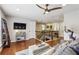 Bright and airy living room with cozy seating, decor, and a mounted TV, creating a welcoming space at 606 Lorimore Pass, Canton, GA 30115