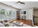 Inviting living room with large windows, hardwood floors, and cozy furnishings, ideal for relaxing and entertaining at 606 Lorimore Pass, Canton, GA 30115