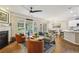 Bright and airy living room boasts a fireplace, large windows, and a view to the kitchen at 606 Lorimore Pass, Canton, GA 30115