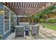 Inviting patio with a pergola, comfortable seating, and a ceiling fan, perfect for outdoor relaxation and entertaining at 606 Lorimore Pass, Canton, GA 30115