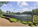 Well-maintained tennis courts surrounded by lush greenery and landscaping, offering a recreational amenity for residents at 606 Lorimore Pass, Canton, GA 30115