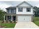 Charming two-story home featuring a two-car garage and landscaped front yard at 123 Deer Xing, Temple, GA 30179