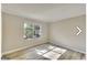 Sunlit bedroom with a large window, neutral walls, and wood-look flooring creates a peaceful retreat at 1399 Cutters Mill Dr, Lithonia, GA 30058