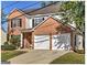 Charming brick and vinyl two-story home with a two-car garage and well-manicured front lawn at 1399 Cutters Mill Dr, Lithonia, GA 30058