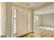 Bright entryway featuring a white front door, sidelights, and light wood-look flooring at 1399 Cutters Mill Dr, Lithonia, GA 30058