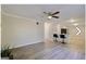 Spacious living room with wood-look flooring, a ceiling fan, and an open view to the kitchen at 1399 Cutters Mill Dr, Lithonia, GA 30058