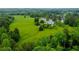 Aerial view of the property showcasing a large, well-maintained lawn, mature trees, and a beautiful home at 1415 N Flat Rock Rd, Douglasville, GA 30134