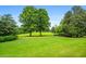 Expansive backyard features lush green lawn and mature trees, perfect for outdoor activities and relaxation at 1415 N Flat Rock Rd, Douglasville, GA 30134