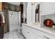 Well-lit bathroom with white cabinets, tub, and ornate design details at 1415 N Flat Rock Rd, Douglasville, GA 30134