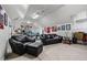 Upstairs bonus room with a large black couch, ping pong table and ceiling fans at 1415 N Flat Rock Rd, Douglasville, GA 30134
