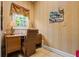 Cozy home office with a built-in desk, wainscoting, and natural light at 1415 N Flat Rock Rd, Douglasville, GA 30134