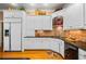 Charming kitchen featuring white cabinets, black countertops, and modern appliances at 1415 N Flat Rock Rd, Douglasville, GA 30134