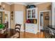 Eat-in kitchen features a white china cabinet, hardwood floors and natural light at 1415 N Flat Rock Rd, Douglasville, GA 30134