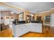 Stylish kitchen with black countertops and white cabinets adjacent to a Gathering room at 1415 N Flat Rock Rd, Douglasville, GA 30134