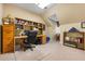 Bright home office features built-in bookshelves and a desk area with natural light from the window at 1415 N Flat Rock Rd, Douglasville, GA 30134