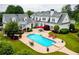 Beautiful backyard features a large swimming pool with lounge chairs and lush landscaping at 1415 N Flat Rock Rd, Douglasville, GA 30134