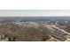 Panoramic aerial view of the mixed-use community, showcasing the neighborhoods, trees, and shopping areas at 385 Rowes Cir, Alpharetta, GA 30009