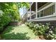 Serene backyard featuring a jacuzzi tub, complemented by lush greenery and well-maintained landscaping at 385 Rowes Cir, Alpharetta, GA 30009
