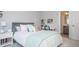 Comfortable bedroom featuring neutral walls, a bed with stylish pillows and access to an ensuite bathroom at 385 Rowes Cir, Alpharetta, GA 30009