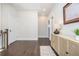 Upstairs hallway featuring hardwood floors, neutral paint, and decorative furniture and art at 385 Rowes Cir, Alpharetta, GA 30009